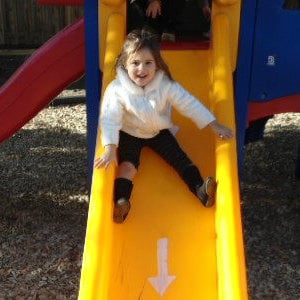 little girl playing slide
