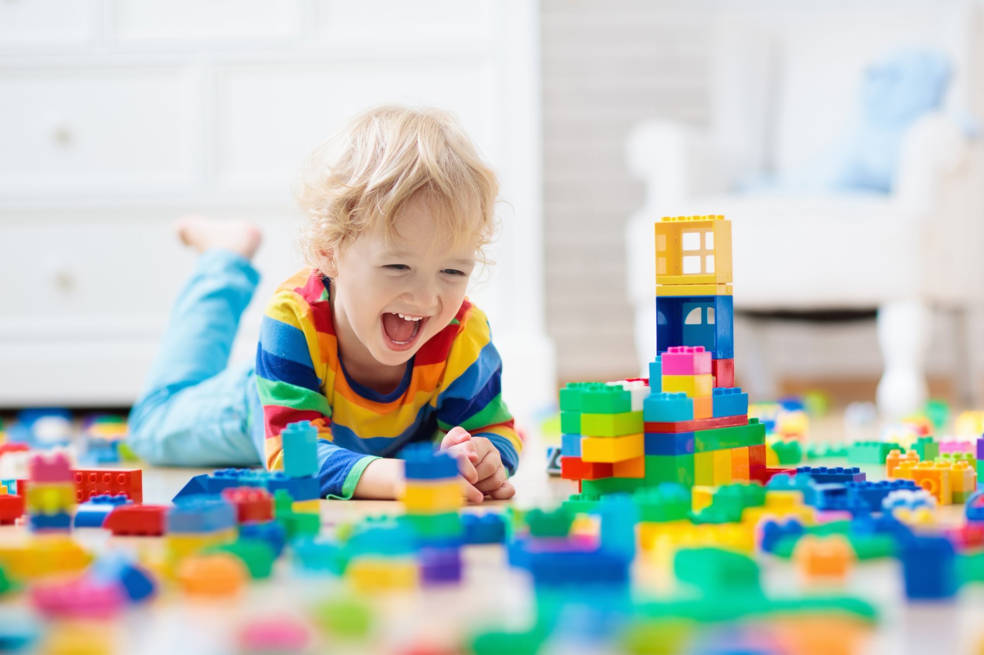 Kid laughing with legos