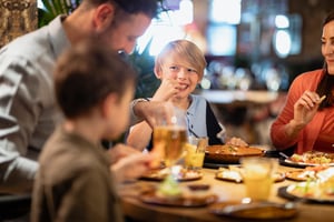 A family having a meal together in a north olmsted restaurant.