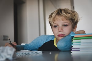 little boy tired stressed and anxious about homework 