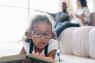 A preteen child reading book fairy tales novels learning at home. 
