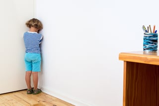 Child in naughty corner, swearing, having time out or having a tantrum.