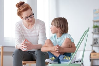 A mom having serious conversation with her son about telling the truth.