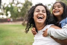 mother having fun with her daughter outdoor 