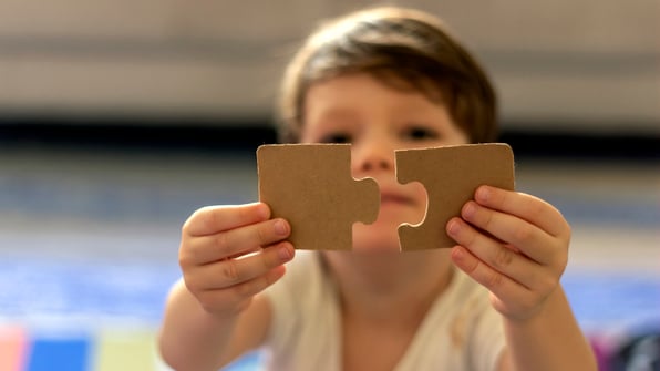 child completing a preschool puzzle