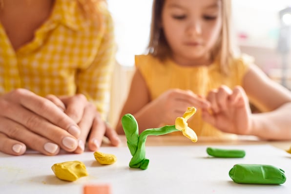 preschooler making playdough at home