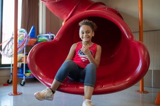 A student enjoys the slide at Horizon Education Centers Old Brooklyn location.
