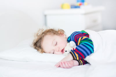 toddler sleeping in bed